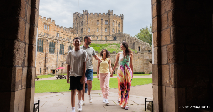 Family walking into Durham Castle, with castle tower visible in the background.